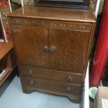 A Lebus Furniture tall boy cabinet, consists of two doors and two drawers