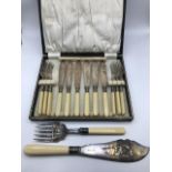 A Vintage E.P Boxed cutlery set together with an ornate serving knife and fork, Has a Sheffield sil