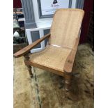 A Victorian plantation chair, Has extending leg rests, Handwoven cane seat area, Possibly India