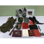 A Lot of military items which includes Gas mask, Russian medals, booklets & badges etc