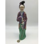 An early 20th century Chinese hand painted geisha lady figurine, Stamped to base, Measures 29cm in