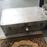 A Vintage metal travel trunk filled with a Queen Anne tea/dinner service and various odds