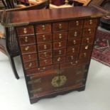 A 20th century oriental medicine cabinet fitted with multiple drawers and two under doors.