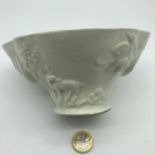 A Victorian USA Import Mark "China" Blanc-de-chine oriental style bowl depicting stork, stag, dragon