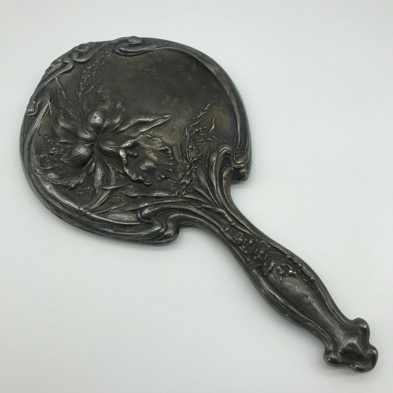 A Lovely Art Nouveau Chester silver hand mirror, designed with raised flower and foliage, Makers J &