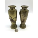 A Pair of bronze/ Brass oriental stork vases. Designed with reeds and storks.