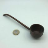 A 18th century hand carved wooden ladle. Measures 20cm in length