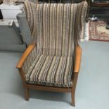 A Retro teak and material wing back arm chair.