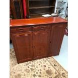 A Late 20th century bookcase unit, designed with two drawers and 3 doors.