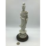 A 19th century Chinese Blanc-de-chine Guanyin figure, sat upon a hardwood stand. Measures 29cm in