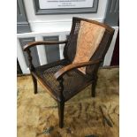 A Victorian arm chair with bergere back and seat area.