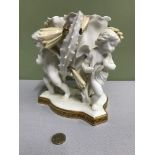 A Moore Pottery cherub triple figure vase. Ornately designed with flowers and gilt trims. Measures