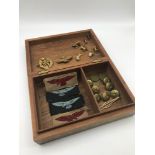 A Hardwood inlaid box containing R.A.F Military patches, buttons , Cap badges and various loose