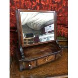 A Regency Feathered Mahogany swivel mirror fitted with 3 small drawers.