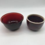 A 19th century Chinese ruby glass drinking cup together with pottery saki cup (20th century)