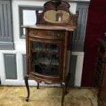 A Victorian Mahogany Serpentine single door display cabinet, designed with a mirror backing &