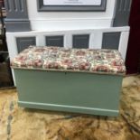 Antique painted wooden chest with upholstered top, Handles to the sides and on castor feet.