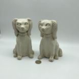 An old pair of studio pottery dog figures signed MF to the base. Measure 16.5cm in height