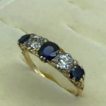 An 18ct gold ladies 5 stone Sapphire and diamond ring. Two Round 0.5ct diamonds (1ct) and 3