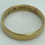 An 18ct gold wedding band, Ring size R. Weighs 3.36grams