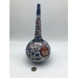 A 19th century Japanese long neck vase designed in the Imari pattern. Measures 27cm in height