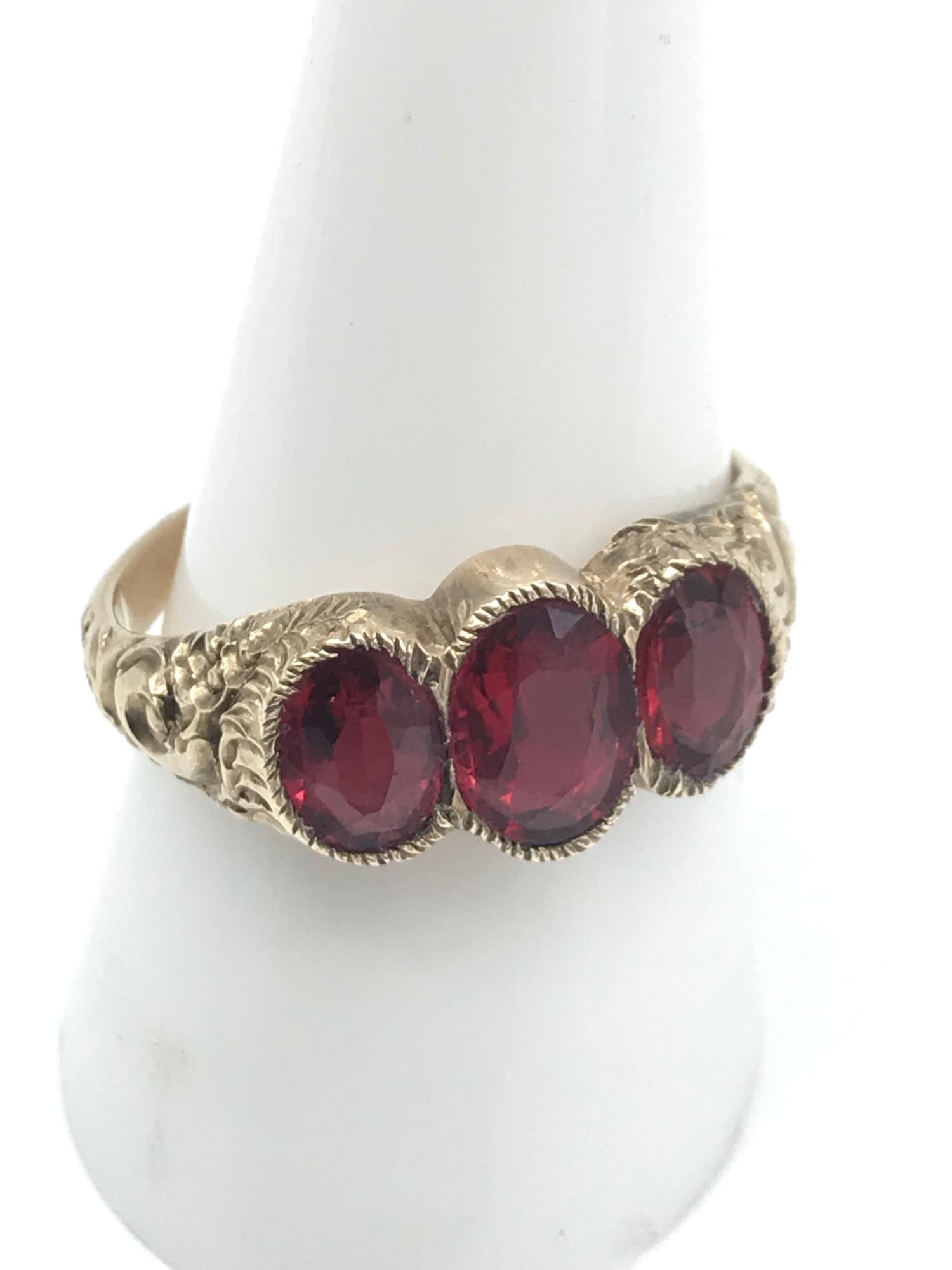 A Victorian ornate ladies gold ring set with 3 large ruby stones, Ring size P, Largest measures