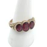 A Victorian ornate ladies gold ring set with 3 large ruby stones, Ring size P, Largest measures