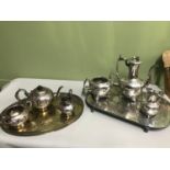 A Lot of two EP Three piece tea services together with two silver plated serving trays