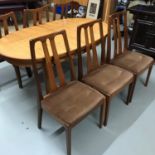 A Retro teak Nathan extending dining table with 6 dining chairs.