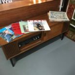 A Retro teak pedestal radiogram cabinet. Fitted with Falcon radio and turntable. Comes with