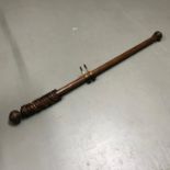 A Dark wood antique style curtain pole. Measures 170cm in length
