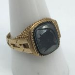 A Gents 9ct gold signet ring set with a black onyx stone engraved with a Roman head. Ring size S 1/