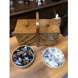 A Light oak canter-lever sewing box filled with threads together with a tin of vintage buttons.