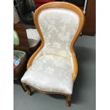 A reproduction spoon back bedroom chair upholstered with a oriental themed material