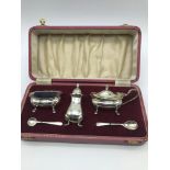 A Boxed Birmingham silver condiment set, made by John Rose, Dated 1965. Has original blue glass