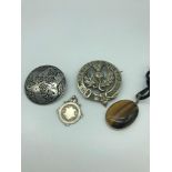 Two pewter Celtic design brooches, Silver Fob medal & Silver and tiger eye pendant.