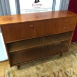 A Mid century Avalon teak pedestal bookcase, set with 2 drawers, pull down front & two sliding glass