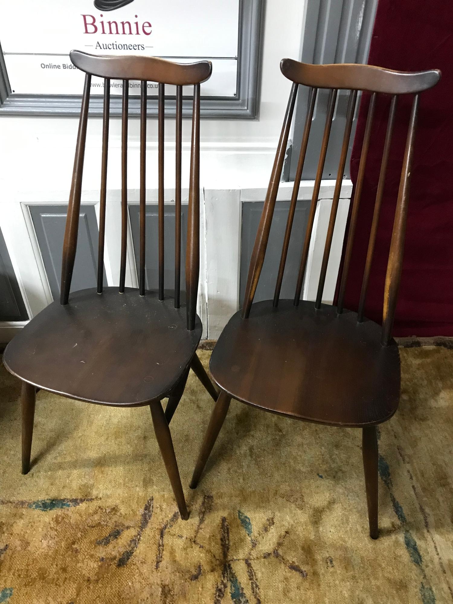 A Set of 4 Ercol elm wood spindle back chairs.