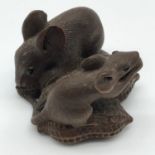 A 19th century Japanese hand carved wooden netsuke of two mice eating peanuts, Signed to the base.