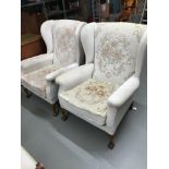 A Pair of gull wing Parker Knoll arm chairs, designed with ball and claw foot supports.