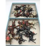 Two trays of antique lead hand painted military figures on horseback. Made by Britains.