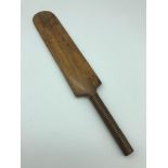 Antique hand carved miniature cricket bat. Measures 25.5cm in length