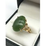 An antique gold ring set with a large oval shaped jade stone, Ring size J, Weighs 3.60 grams,