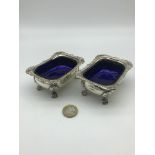 A Pair of Georgian London silver mustard pots with blue liners, Supported on claw feet, Maker