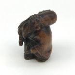 A hand carved Meiji period Japanese lucky god figure, signed to the base. Measures 5cm in height