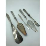 A Lot of 4 silver handled serving items together with an 830 grade Maltese silver butter knife.