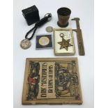 A Lot of collectables which includes 1939 Half dollar coin, Military African star medal, Military