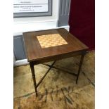 A Regency style games table, Inlaid chess design to the top, removable top, supported on turned legs