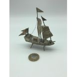 A Silver oriental model of a junk boat, Measures 10cm in height