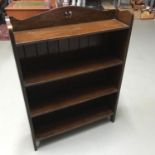 An early 20th century dark oak bookcase, styled in an arts and crafts manner. Measures 106x77x19cm